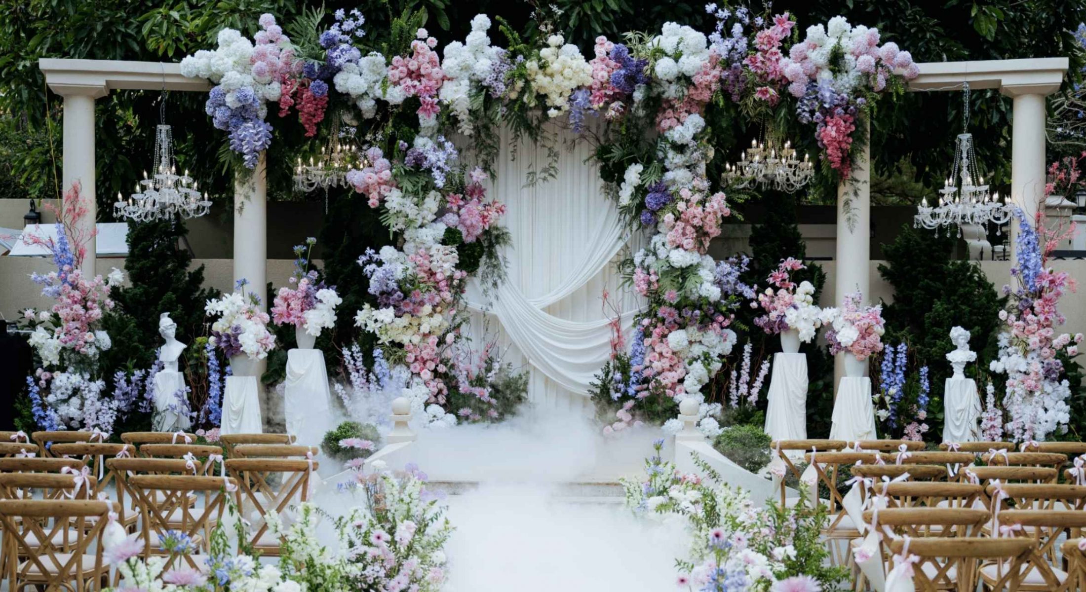 Wedding ceremony setup with pastel flowers and chandeliers at Grand Mercure Dalat